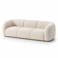 Canapé trois places en tissu bouclé beige